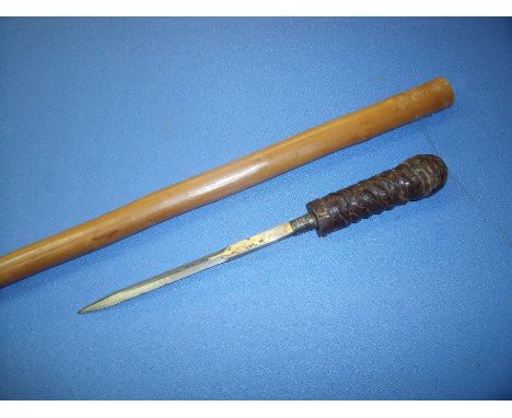 Early 20th C walking cane with removable dagger, the leather bound grip with screw off action revealing 8 inch double edges b