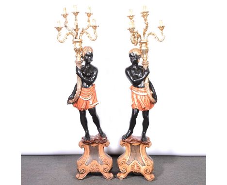 Pair of carved and painted wood blackamoor floor standing candelabra, the figures on scrolled plinths and each supporting six