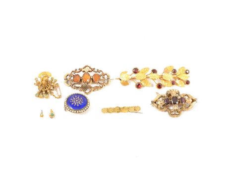A collection of six Victorian brooches, some with damage, a gold-plated leaf spray with garnet stones; two scroll brooches se