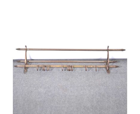 A metal kitchen wall rack, the lower rail with thirteen moveable pot/ utensil hooks, below a two rail shelf, width 119cm, dep