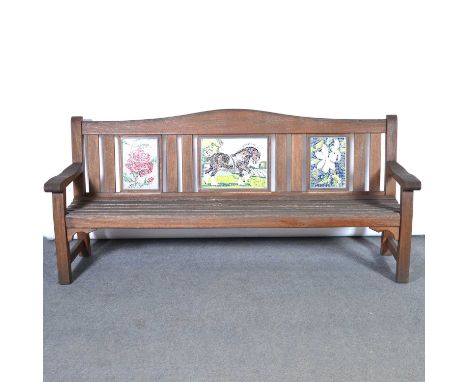 Large teak garden bench, the back set with three rectangular mosaic panels, the central panel depicting a shire horse, the ad