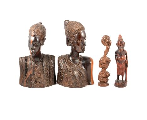 A pair of carved wooden African figures, depicting a man and a woman, 31cm and 32cm; another carved wooden figure of a man wi