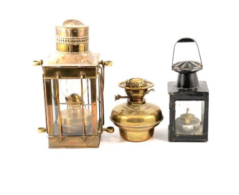 A brass lantern, 39cm; a hand lamp with painted black metal surround; a West German Feuerhand lamp; brass reservoir for an oi