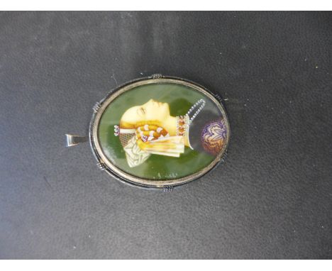A pendant/brooch in the form of a miniature portrait of a lady in a .800 silver mount signed indistinctly to left hand side -