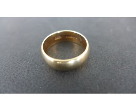 A 9ct gold wedding band weighing approx 4.1 grams - ring size J-K - wear and surface marks consistent with age and use