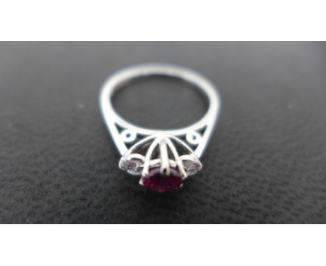 An 18ct white gold ring set with a ruby flanked by two diamonds, size G - Weight approx 1.5 gms Condition report: Ruby has a 