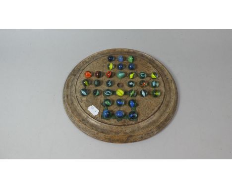 A Circular Wooden Solitaire Game with Vintage Marbles, 26cm Diameter 