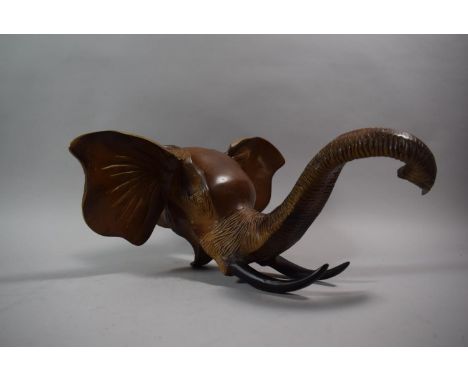 A Cast Metal Wall Hanging Elephant Mask with Trunk in Salute, 38cm Wide 