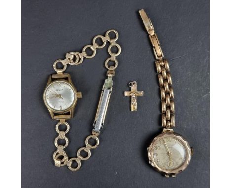 A vintage 9ct gold ladies manual wind wristwatch;&nbsp;together with a gold plated ladies wristwatch; and a small crucifix pe
