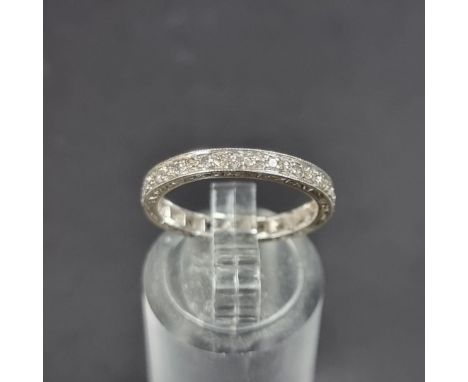 A white metal diamond eternity ring, size K 1/2.
