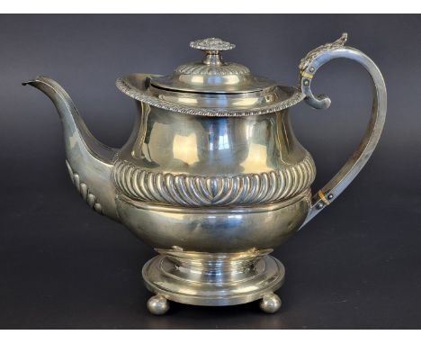 A George IV silver teapot,&nbsp;maker's mark rubbed, London 1820, with ivory insulators, height to handle 20cm, gross weight 