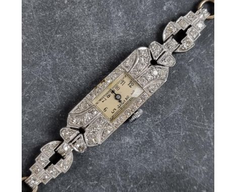 An Art Deco platinum and diamond set manual wind ladies cocktail wristwatch, 11mm x 24mm, on original integrated 9ct gold 'ro