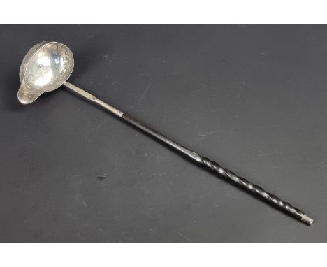 A Georgian white metal and baleen handled toddy ladle. 