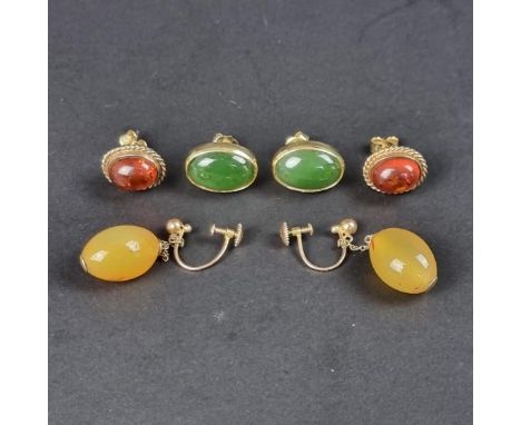 A pair of yellow metal amber cabochon ear studs; together with a pair of yellow metal jade cabochon ear studs; and a pair of 