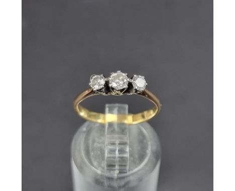 A yellow metal diamond three stone ring, size K 1/2.