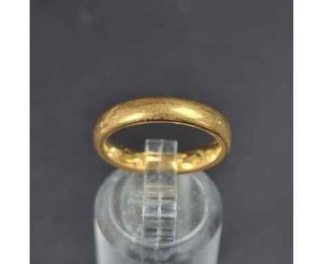 A 22ct gold wedding band, size K, 6.6g.