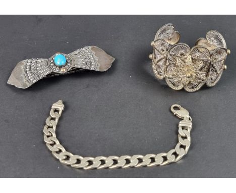 A silver flat curb link bracelet, 31.5g, 20.5cm; together with a filigree bangle; and a hair clip. (3)