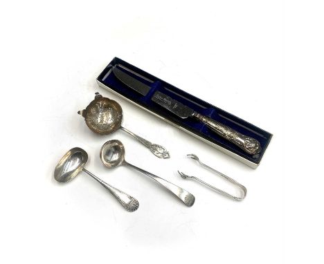 A silver toddy ladle by Andrew Wilkie, Edinburgh 1811, a sauce ladle, Sheffield 1907, a tea strainer by H Hunt Sheffield 1959