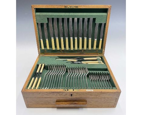 An Aspreys, Bond Street epns oak canteen for nine in Hanovarian Rattail pattern. The suite includes a four-piece carving set,