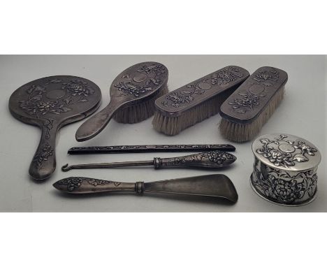 A matched Chinese export silver dressing table set, including silver circular cannister and cover, by Yok Sang, diameter 8.1c