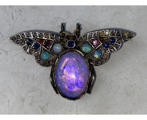 An early 20th century white metal, moon stone, opal, ruby, sapphire and diamond set insect brooch, possibly being a moth, set