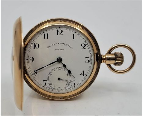 A Sir John Bennett Ltd 9ct. gold half hunter pocket watch, crown wind, having signed white enamel Arabic numeral dial with su