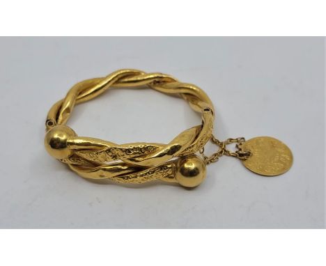 A Turkish precious yellow metal hinged bangle, fashioned from two hollow woven bands, one textured, the other plain polished,