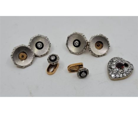 A 14ct. gold and diamond cuff link and shirt collar stud set, the cuff link ocatagonal faces engine turned and bezel set cent