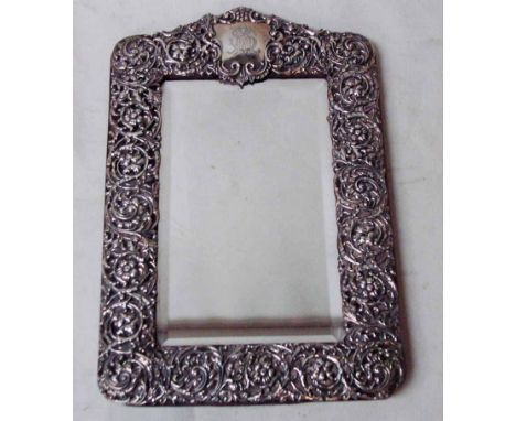 An Edwardian easel table mirror of rectangular form with bevelled glass plate in fabric back frame with intricately pierced a