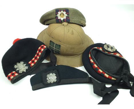 A khaki Glengarry to the Royal Scots, a tropical helmet with tartan patch, a further Glengarry to the Glasgow Highlanders, an