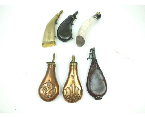 A small collection of powder and shot flasks, comprising a late 18th Century example in polished horn, two further horn flask