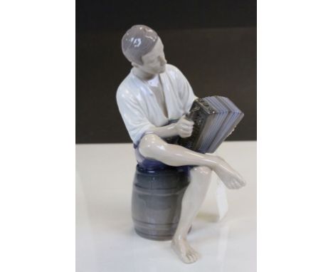 Bing &amp; Grondahl ceramic model of an Accordian player seated on a Barrel, numbered 1661SV and stands approx 22cm