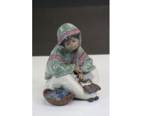 Lladro ceramic model of a seated Fish Seller, approx 15cm tall