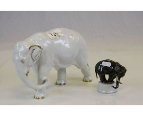 Two vintage ceramic Elephants, the larger marked "Fraureuth Knustabsteilung", the other "Rosenthal 1914 - 1917" with tusk rep