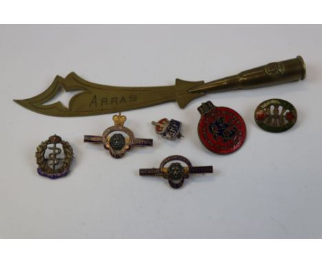 A Small Selection Of Militaria To Include A World War One Trench Art Letter Opener Marked ARRAS And A Selection Of Badges To 