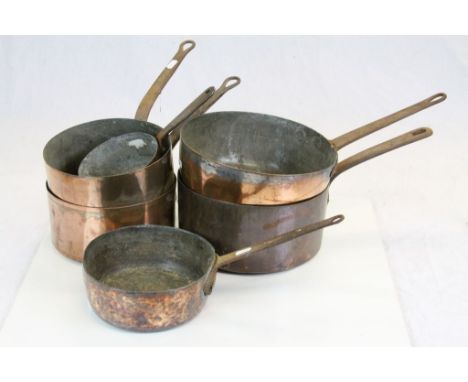 Six vintage Copper saucepans with Cast Iron handles, the largest with a bowl approx 25cm diameter
