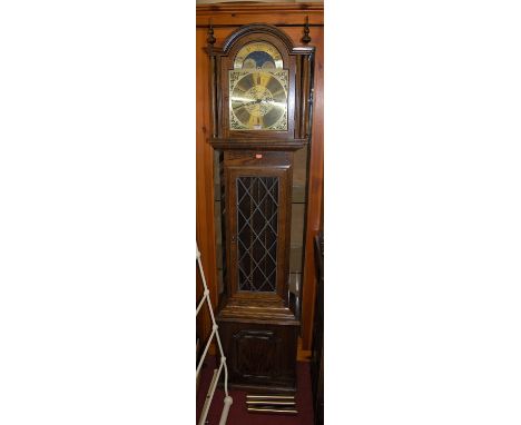 A contemporary oak longcase clock by Fen Clocks of Suffolk having an arched moon phase brass dial, lead glazed trunk door, wi