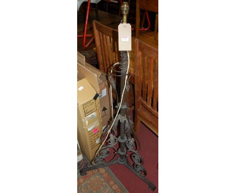 An Arts &amp; Crafts lacquered brass telescopic standard lamp, having floral scrolled decoration