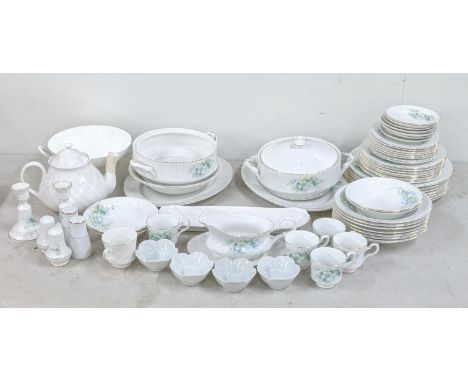 A Royal Staffordshire dinner service decorated with white flowers and foliage to include a salt and pepper shaker, treen and 