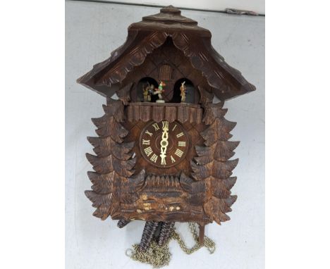 A German black forest carved cuckoo clock with Goebel inset figuresLocation: 