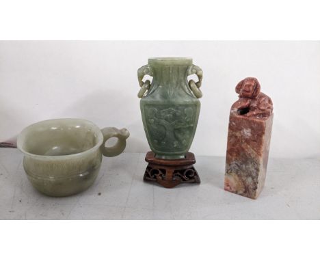 A Chinese soapstone carved seal together with two pieces of Chinese jade to include a celadon taotie vase, raised on a base L