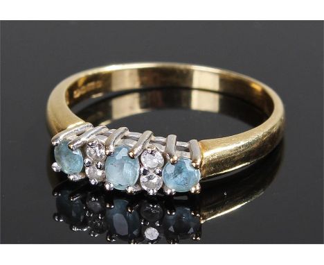 18 carat gold blue topaz and diamond ring, set with three blue topaz and four round cut diamonds, ring size P