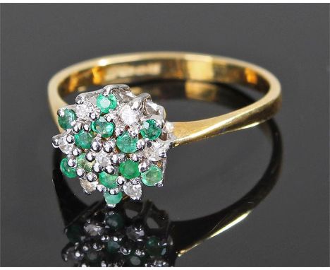 18 carat gold diamond and emerald ring, in the form of a flower head, ring size K