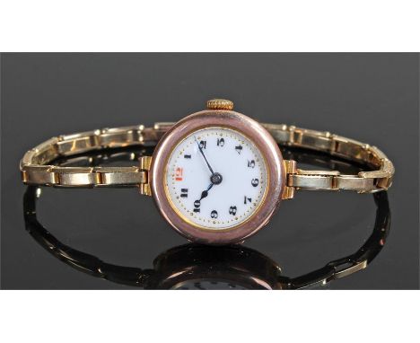 9 carat gold ladies wristwatch, the rose gold case with white enamel dial and Arabic hours, manual wound with a 9 carat gold 