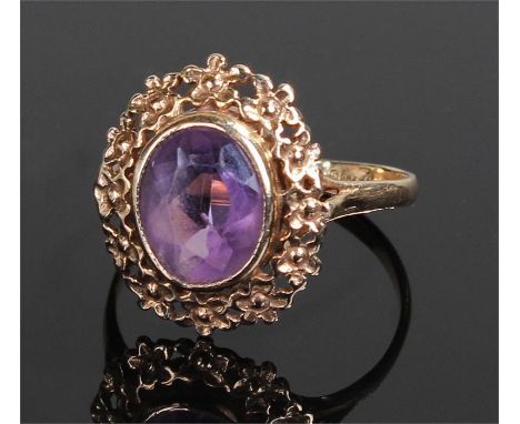 9 carat gold amethyst ring, with an oval amethyst in a  foliate border, ring size Q