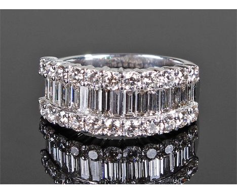 Impressive 18 carat white gold diamond set ring, the central band of sixteen baguette diamonds flanked by two bands of twenty