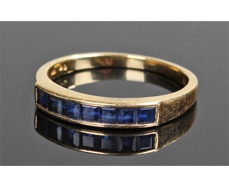 18 carat gold sapphire ring, the row of square cut sapphires to the head, ring size N