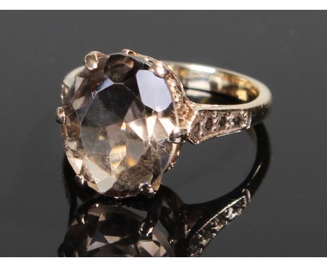 9 carat gold smoky quartz ring, with an oval smoky quartz on high shoulders, 