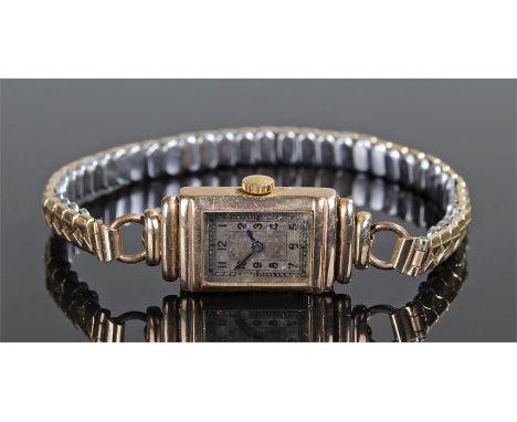 Ladies 9 carat gold wristwatch, the silvered dial with Arabic hours, rectangular stepped case, manual wound, case 14mm diamet