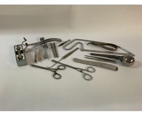 A collection of medical items, including surgical instruments, vintage syringes x4, and a hip replacement ball joint.  O rese